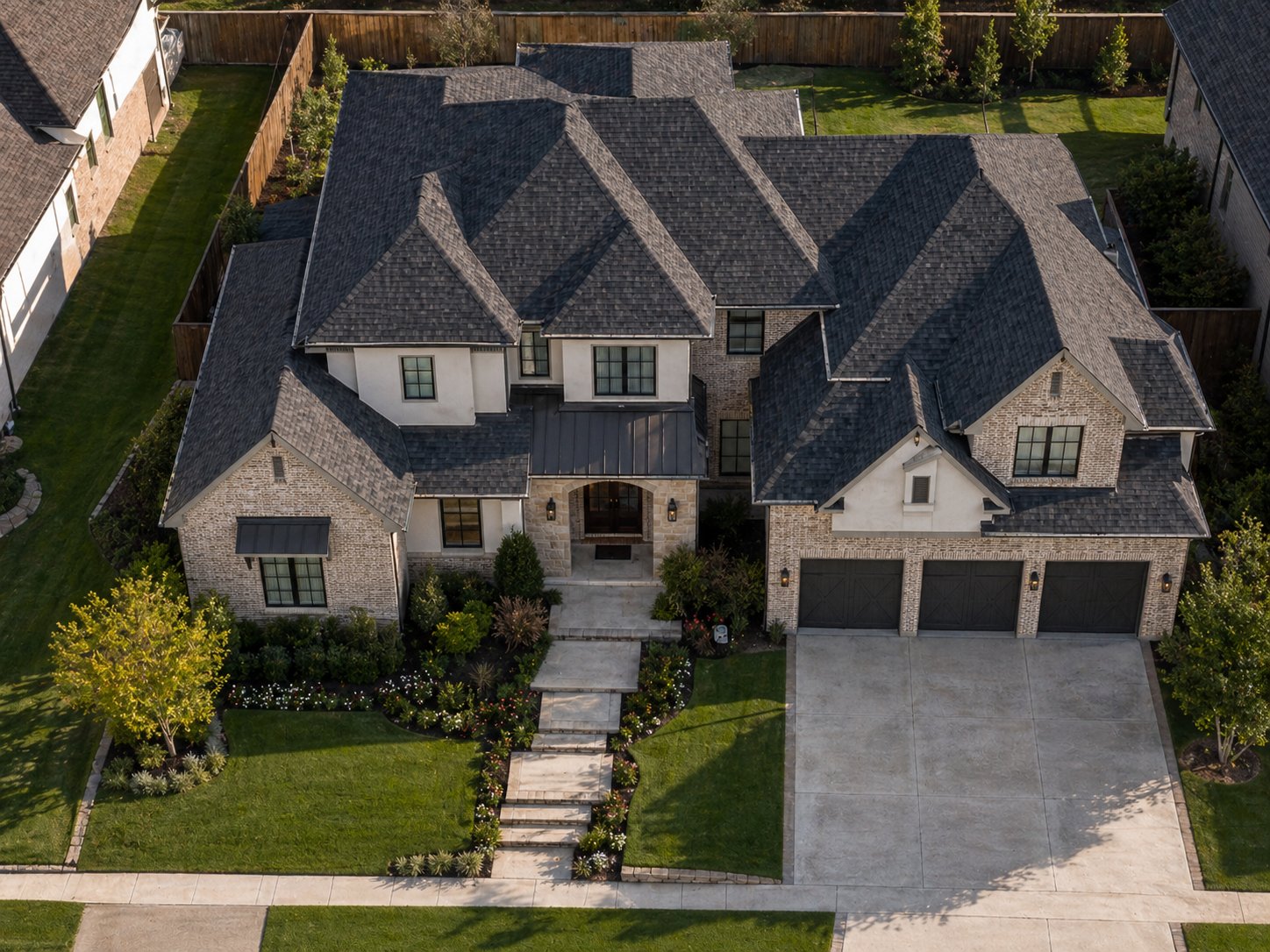 Aerial view of traditional brick and stone custom home in Spring TX